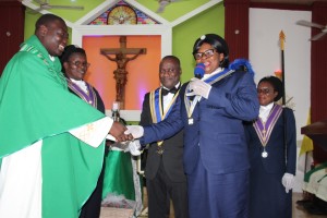 The Parish Priest of St Paul Catholic Church, Kpehe, Very Rev Fr. Peter Rocky Hesse thanking Respected Lady Sister Yennah, the Regional Noble Lady after receiving a donation of GHc10,000 to assist in the church’s projects.